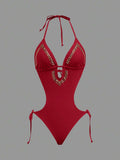 Front studio view of red halter studded cutout one-piece swimsuit with deep V neckline and hip ties for beach party styling