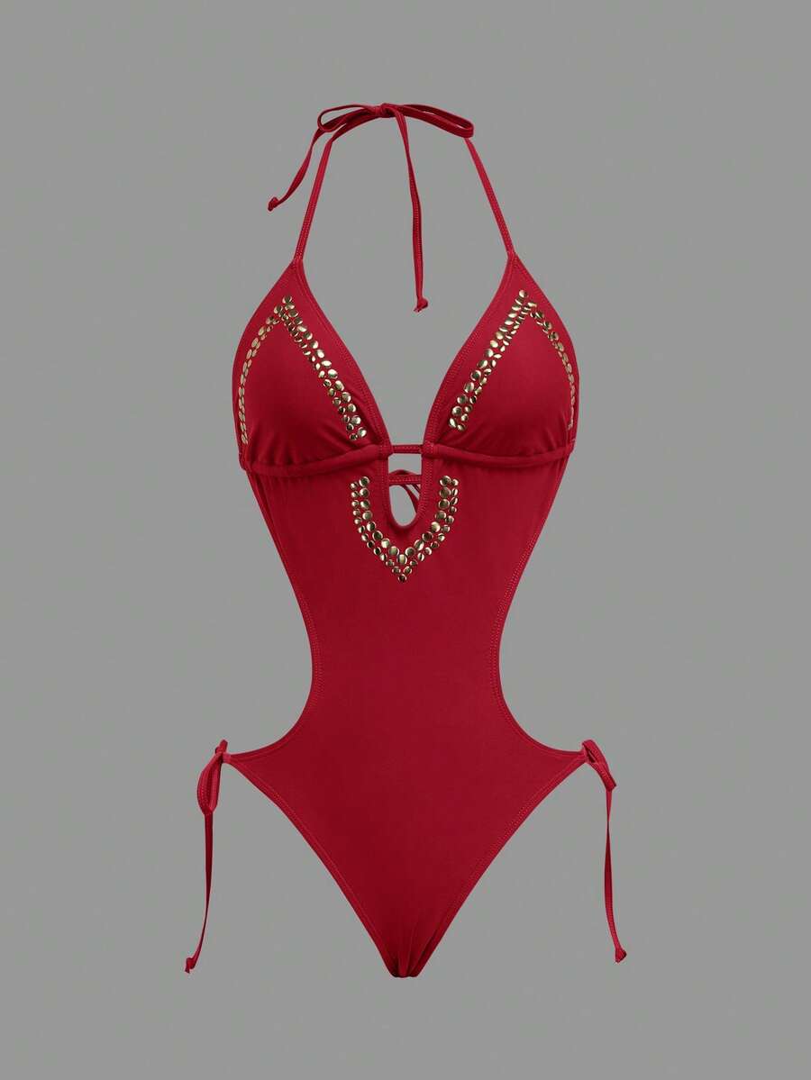 Front studio view of red halter studded cutout one-piece swimsuit with deep V neckline and hip ties for beach party styling