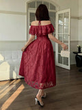 Back view of burgundy floral ruffle midi dress with tied halter straps