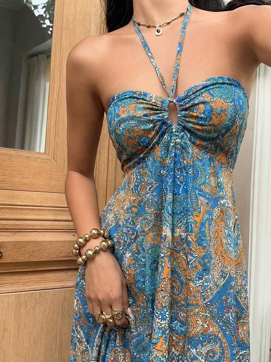 Close-up teal blue mustard paisley dress with ruched bust and keyhole