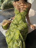 Green paisley halter maxi dress seated front view with coconut and woven bag
