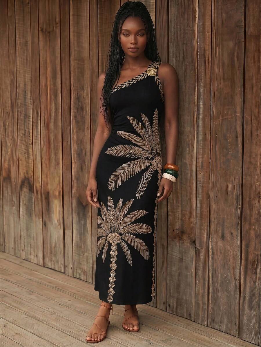 Front view of black palm print one-shoulder maxi dress with gold floral shoulder accent