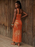 Back view of burnt orange palm print one-shoulder maxi dress with open back