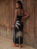 Back view of black palm print one-shoulder maxi dress with open back