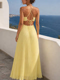 Yellow pleated open-back maxi dress with crossed straps and tie closure, rear view
