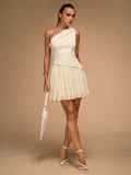 Cream one-shoulder mini dress with structured bodice and pleated skirt
