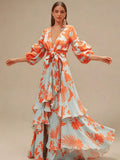Full front motion view of coral tropical print belted maxi dress with cascading ruffles