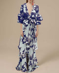Full front view of pale blue and navy tropical print belted maxi dress with tiered skirt
