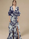 Front studio view of navy botanical wrap maxi dress with deep V-neck and ruffled hem