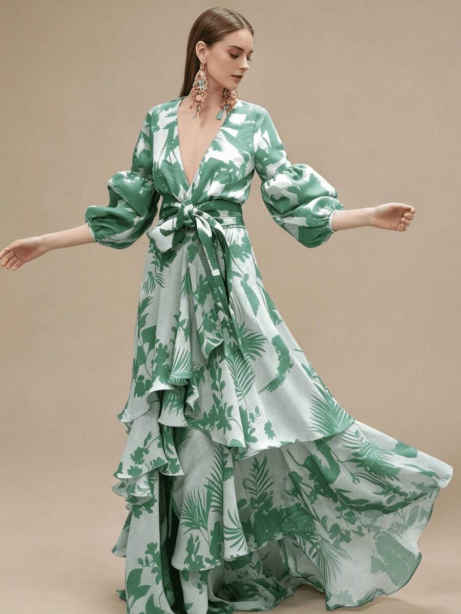 Three-quarter motion view of green tropical print maxi dress with flowing asymmetric ruffles