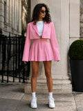 Front view of pink cropped blazer and high-waisted pleated mini skirt set