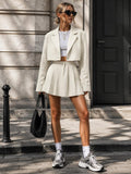 Front view of cream cropped blazer and pleated mini skirt two-piece set