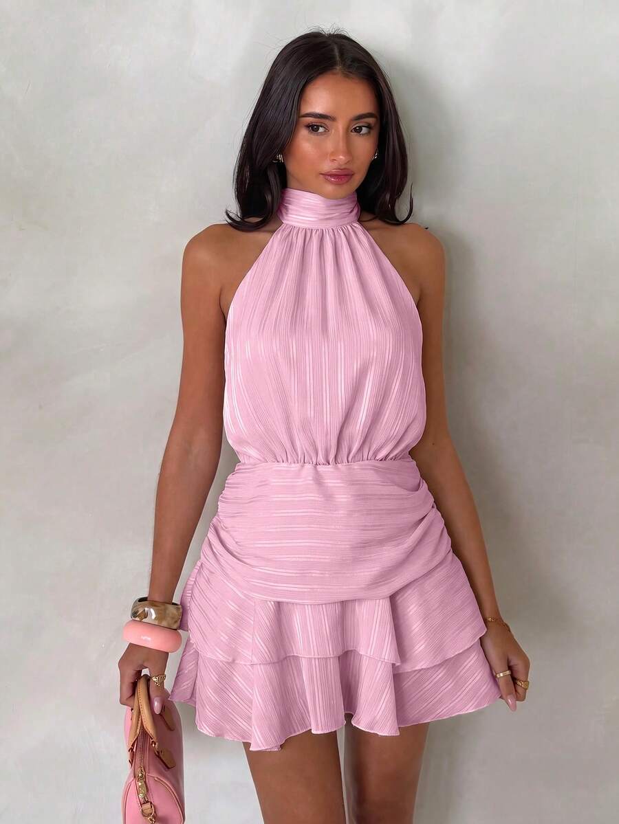 Front view of pink halter mini dress with gathered waist and tiered hem