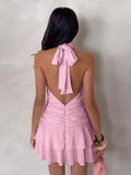 Back view of pink halter mini dress with tied neck and open V back