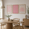 Pink floral figurative and botanical poster triptych in a bright dining room
