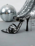 Side profile of black snakeskin cross-strap sandal with sculpted stiletto heel