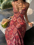 Red paisley halter maxi dress seated front view with coconut and woven bag