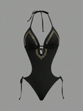 Front studio view of black halter studded cutout one-piece swimsuit with deep V neckline and hip ties for beach party styling