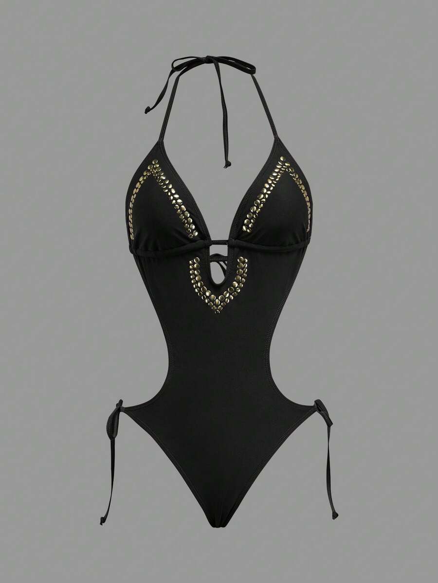 Front studio view of black halter studded cutout one-piece swimsuit with deep V neckline and hip ties for beach party styling