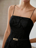 Close-up of black rose texture jumpsuit square neckline and waist-defining belt