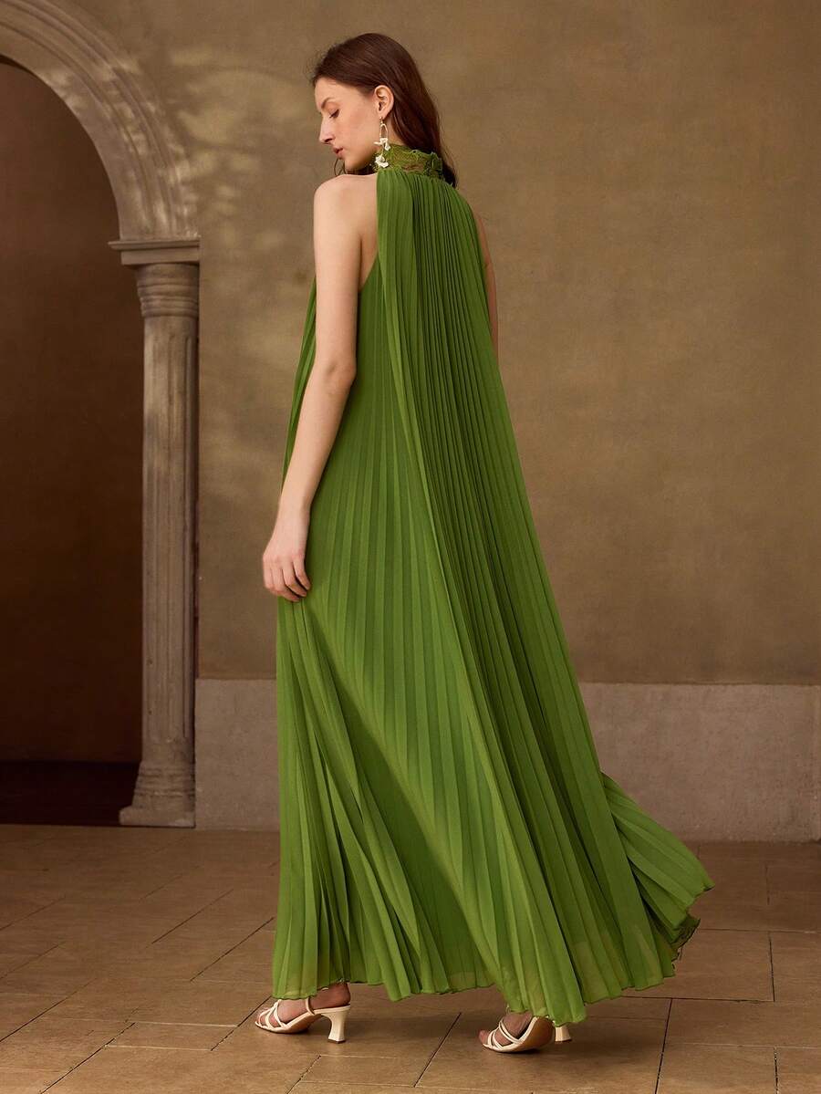Rear walking view of olive-green pleated maxi dress with bare shoulders and lace halter neckline