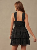 Front view of tiered ruffle polka dot mini dress with halter bow