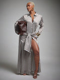 Front view of brown striped button-front maxi dress styled with a brown handbag for workwear