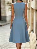 Full rear view of powder blue sleeveless A-line midi dress in an outdoor architectural setting