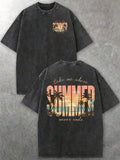Royal blue loose fit T-shirt with a colorful beach sunset back design