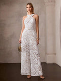 Full front view of ivory floral halter jumpsuit with gold buckle and floor-length palazzo legs