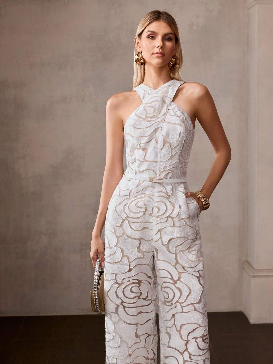 Front three-quarter view of ivory raised-rose jumpsuit styled with gold accessories and mini bag