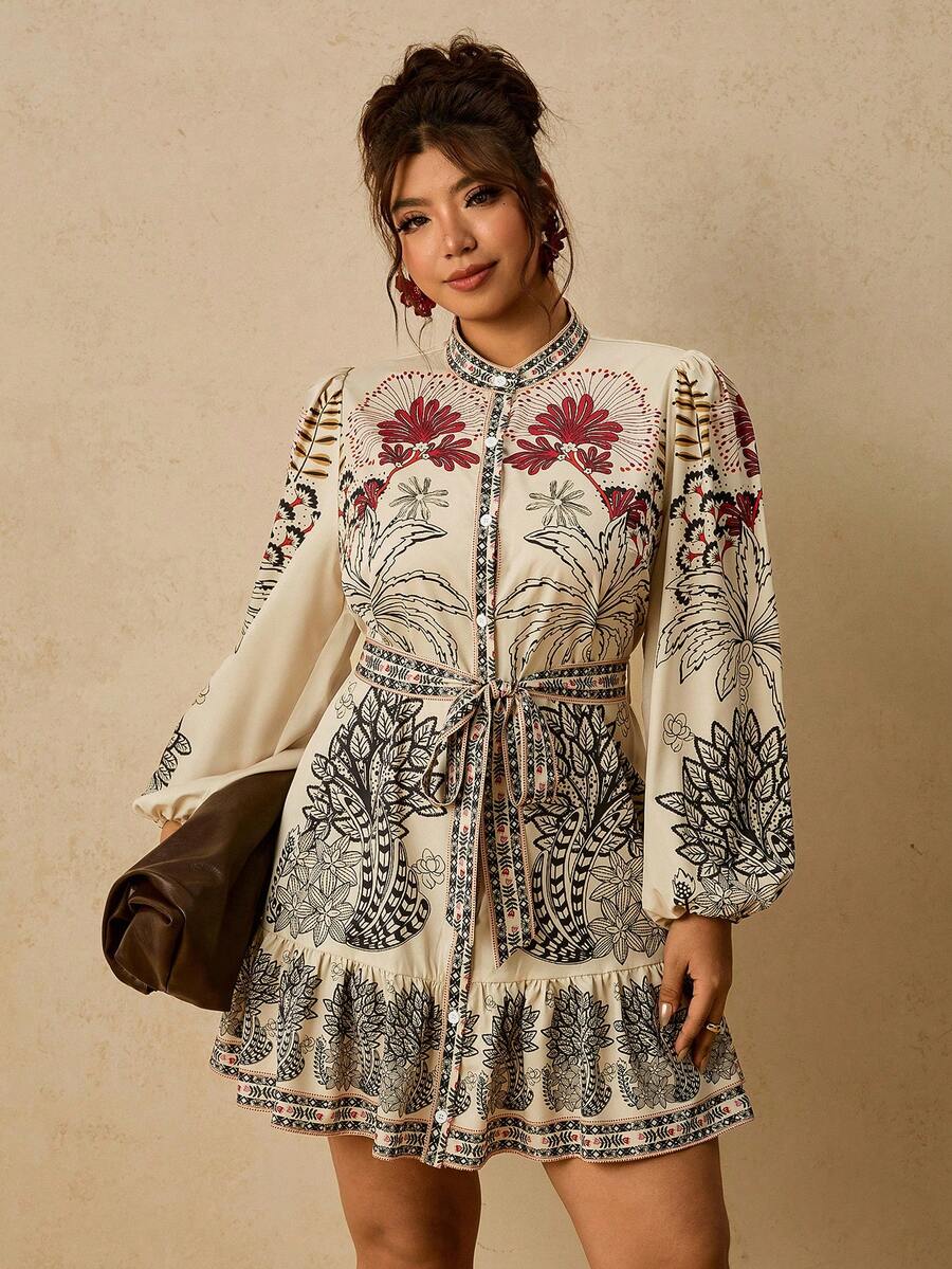 Front three-quarter view of cream tropical plus size shirt dress with tie belt