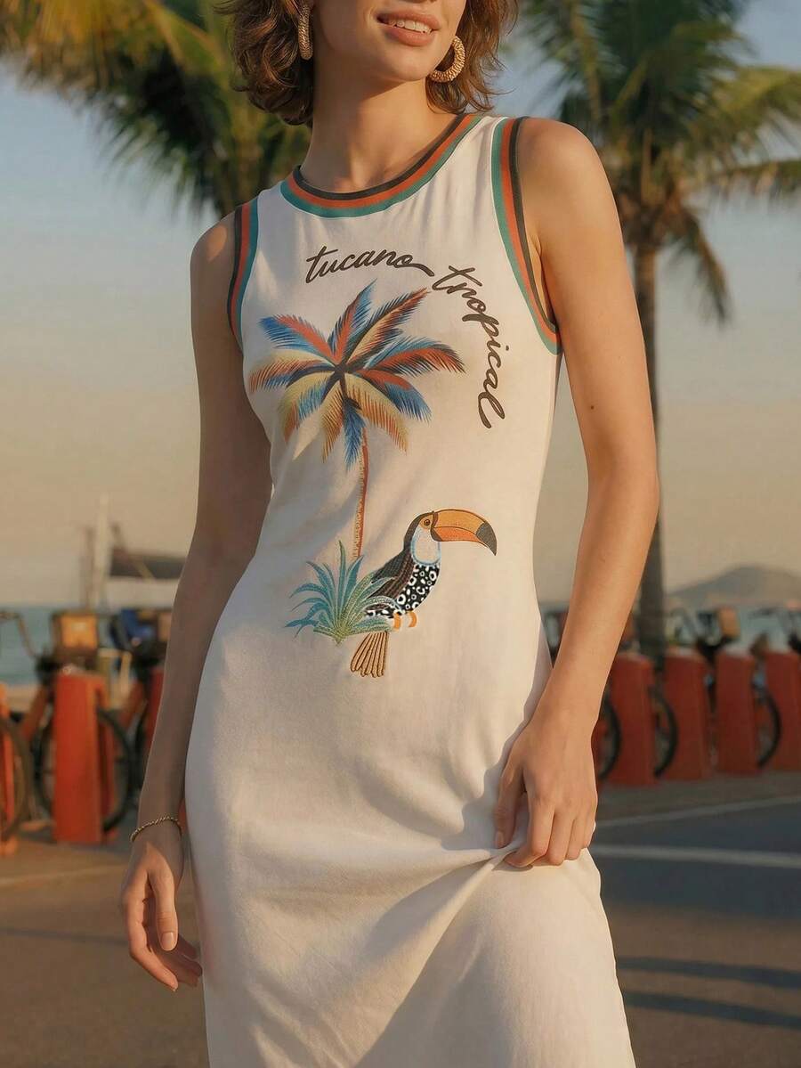 Front view of ivory tropical toucan maxi dress on waterfront promenade