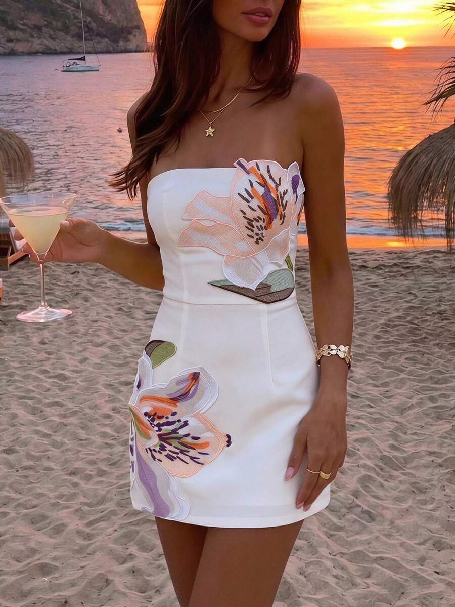 White fitted strapless mini dress with floral appliqué and a clean silhouette