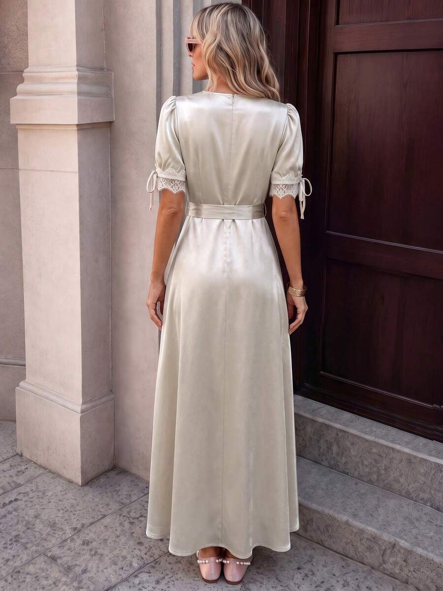 Front three-quarter view of champagne lace satin maxi dress with V neck and thigh slit