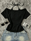 Alternate flat lay of black fitted off-shoulder halter top with denim skirt