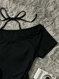 Close-up of black off-shoulder halter top with bow ties and smooth stretch finish