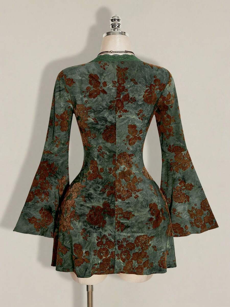 Rear mannequin view of green floral mini dress showing shallow scoop neck and shaped waist seams