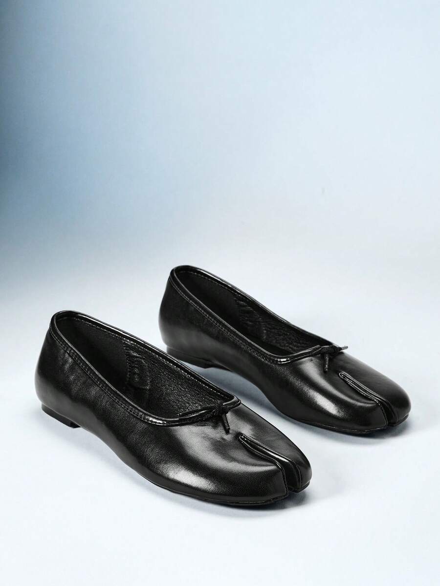 Model wearing black smooth split-toe ballet flats