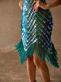 Close-up of teal sequin swim cover-up showing sheer diamond mesh and long uneven fringe