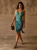 Full front view of teal sequin swim cover-up styled with a fringed bag for resort wear