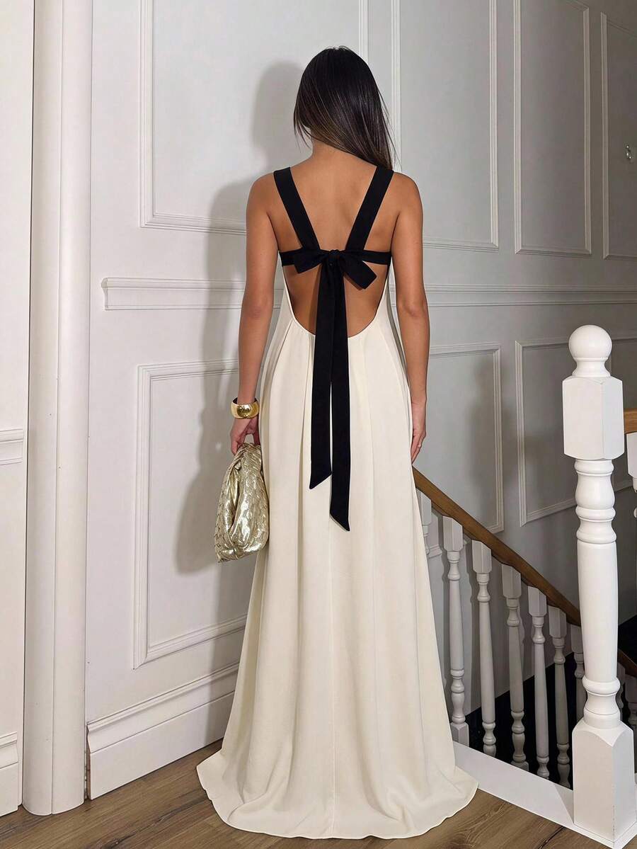 Front view of ivory maxi dress with black shaped cups and shoulder straps