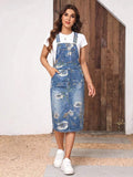Front view of floral medium-wash denim pinafore dress with bib pocket and white tee