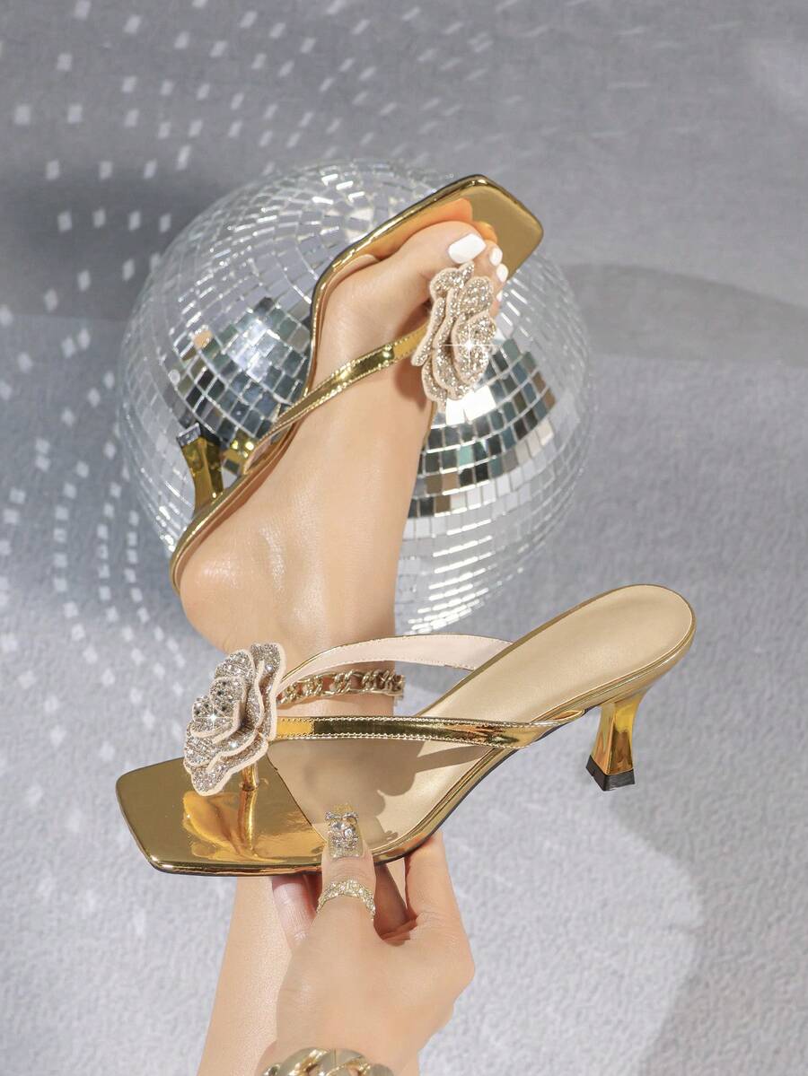 Overhead view of metallic gold rhinestone rose square-toe mule sandals with flared kitten heel for event styling