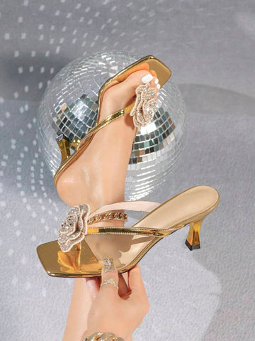 Overhead view of metallic gold rhinestone rose square-toe mule sandals with flared kitten heel for event styling