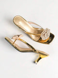Overhead side view of metallic gold rhinestone rose square-toe mule sandals with flared kitten heel for event styling