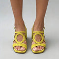 Front view of yellow open toe criss-cross buckle block heel sandals on model