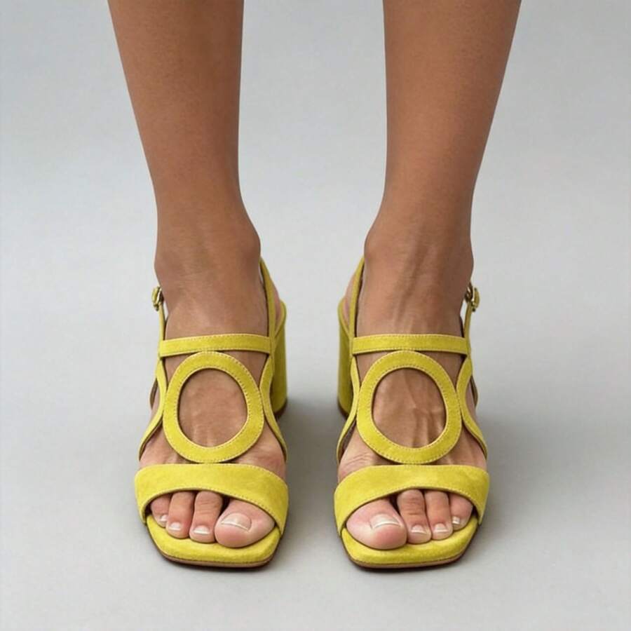 Front view of yellow open toe criss-cross buckle block heel sandals on model