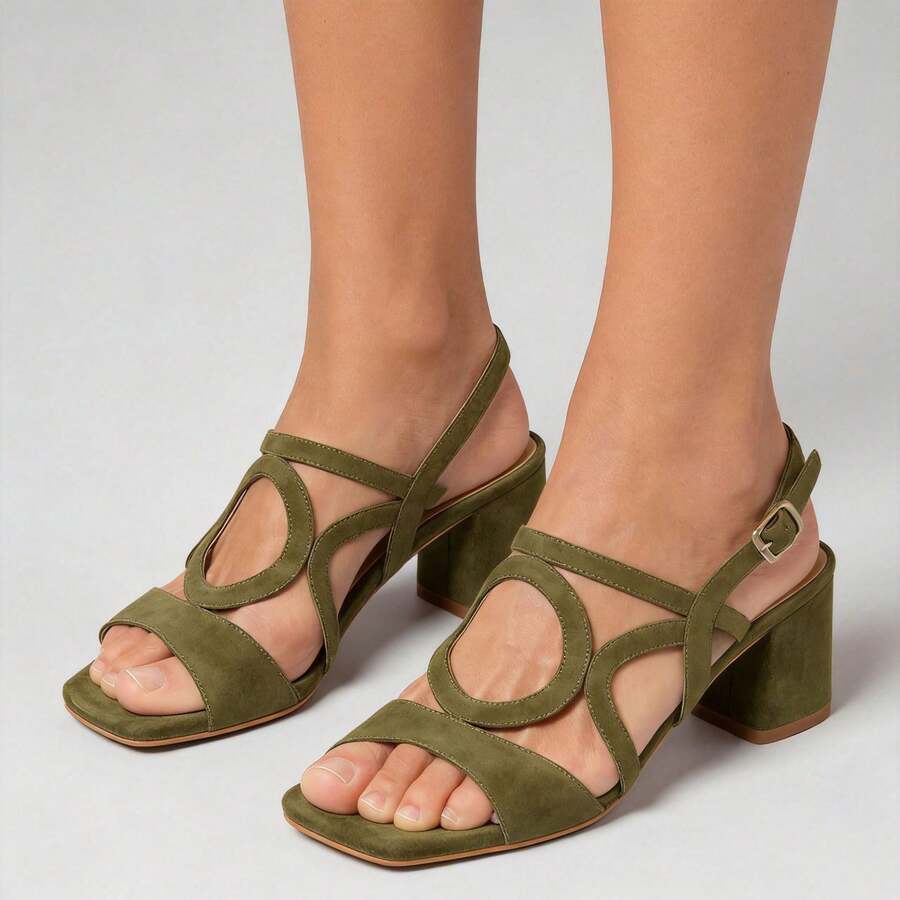 Three-quarter view of olive green strappy square toe block heel sandals on model