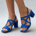 Three-quarter view of cobalt blue open toe square toe block heel sandals on model